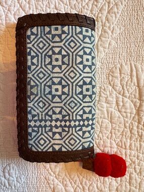 Noonday Collection Blue Patterned Wallet with Brown Trim and Red Pom Accent